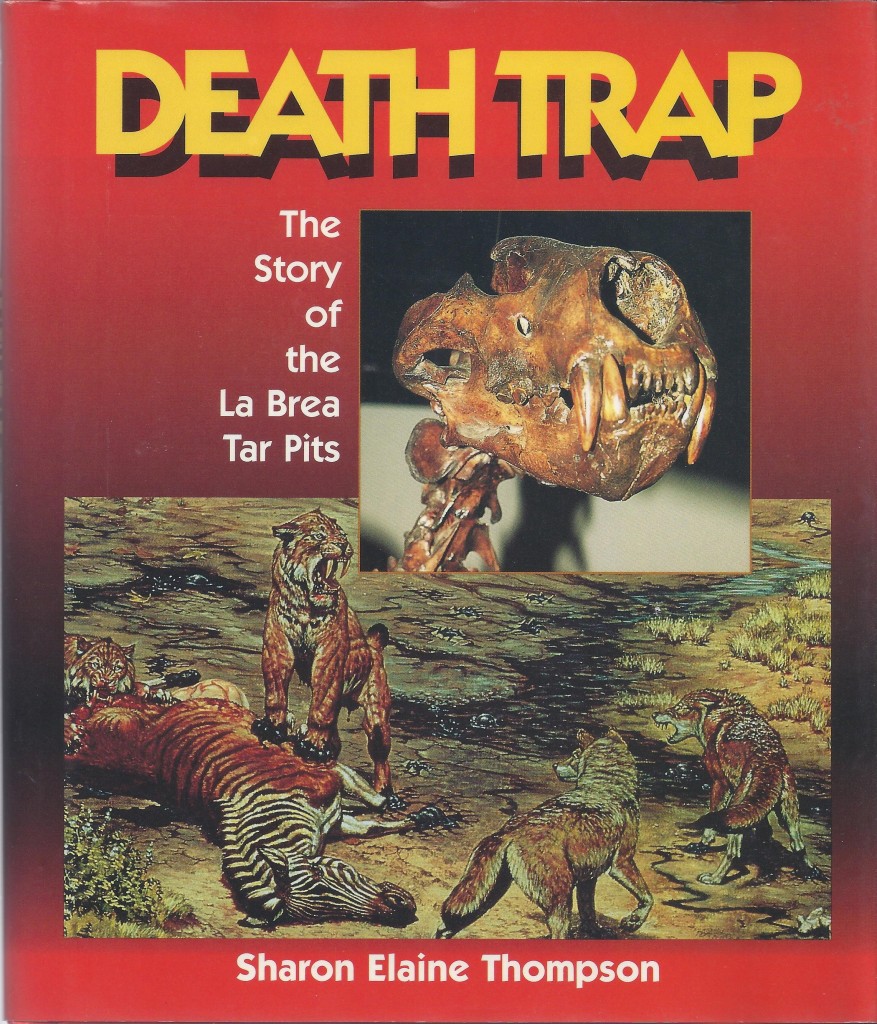 Cover shows skull of saber-toothed cat and painting by Mark Hallett of prehistoric animals feeding at theTar Pits.